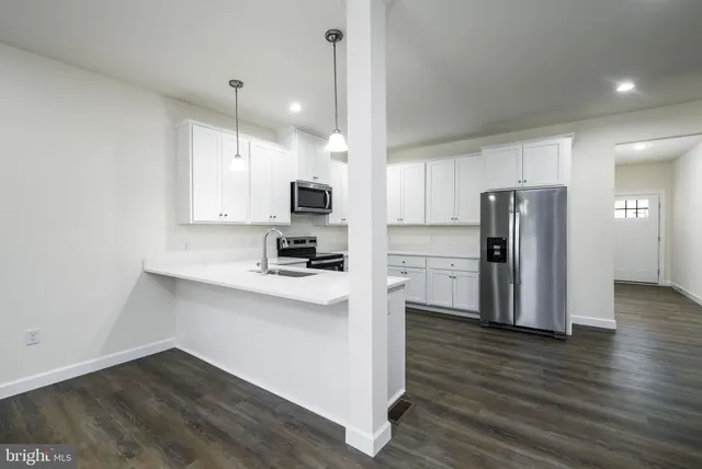 a view of kitchen with refrigerator and window