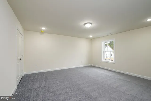 a bathroom with a sink toilet and window