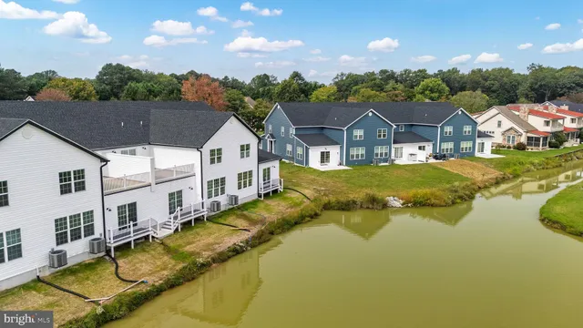 a view of a house with pool and a yard