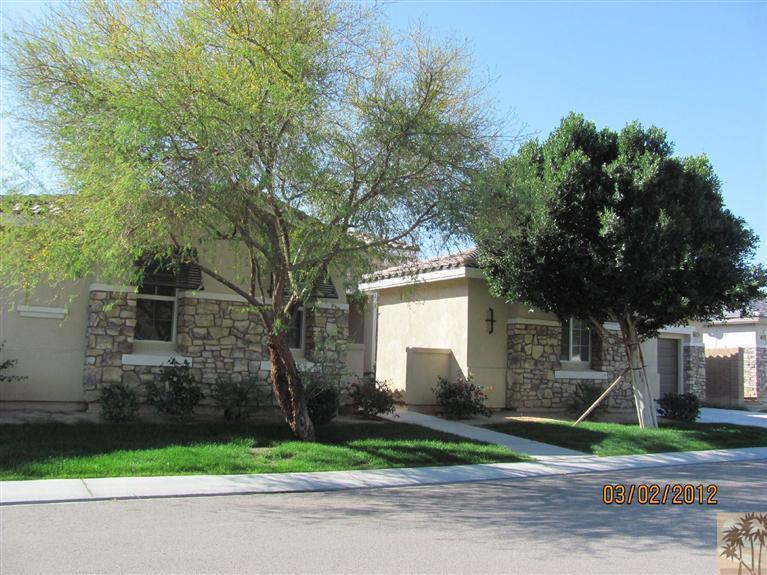 83329 Stagecoach Road Indio, CA 92203 - Photo 1 of 10 a front view of a house with a yard and garage