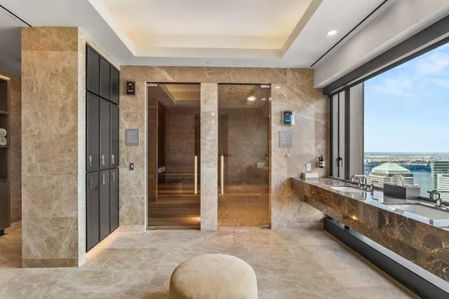 a living room with large window and furniture