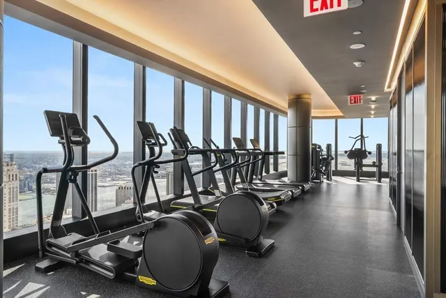 a bathroom with a double vanity sink and mirror with toilet