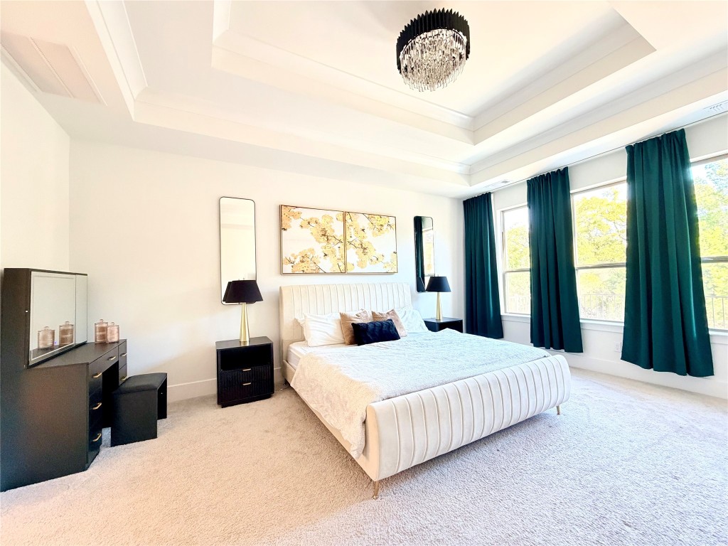 2012 Bayridge Road Georgetown, TX 78628 - Photo 15 of 32 a bedroom with a large bed and a chandelier