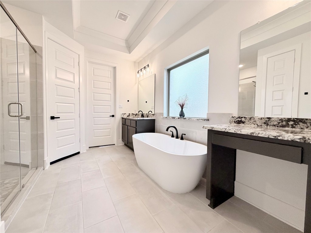 2012 Bayridge Road Georgetown, TX 78628 - Photo 18 of 32 a spacious bathroom with a double vanity sink mirror and bathtub