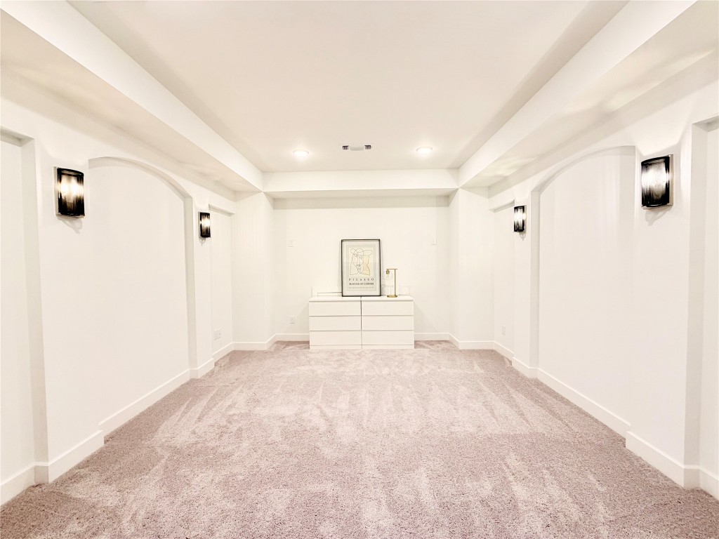 2012 Bayridge Road Georgetown, TX 78628 - Photo 23 of 32 Unfurnished room with arched walkways, carpet, and recessed lighting