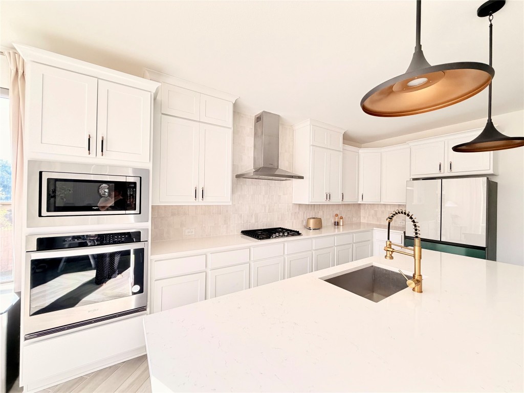 2012 Bayridge Road Georgetown, TX 78628 - Photo 6 of 32 a kitchen with stainless steel appliances a stove a sink and a microwave