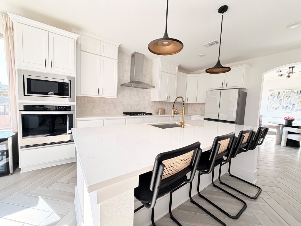 2012 Bayridge Road Georgetown, TX 78628 - Photo 7 of 32 a kitchen with stainless steel appliances kitchen island granite countertop a stove a sink a microwave and a dining table