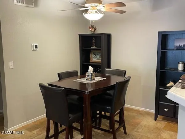 a dining room with a table and chairs
