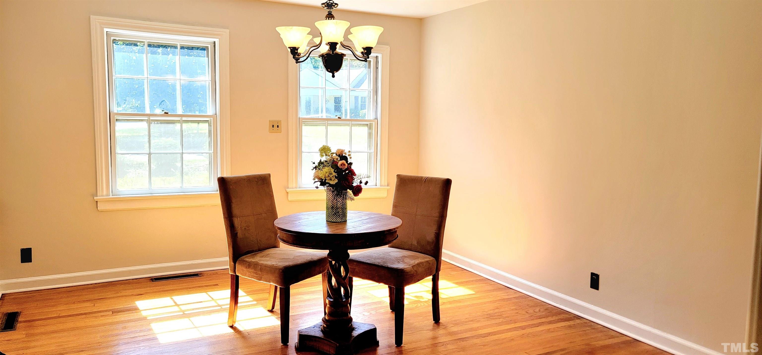 2245 Sheffield Road Raleigh, NC 27610 - Photo 4 of 8 a view of a dining room with furniture and wooden floor