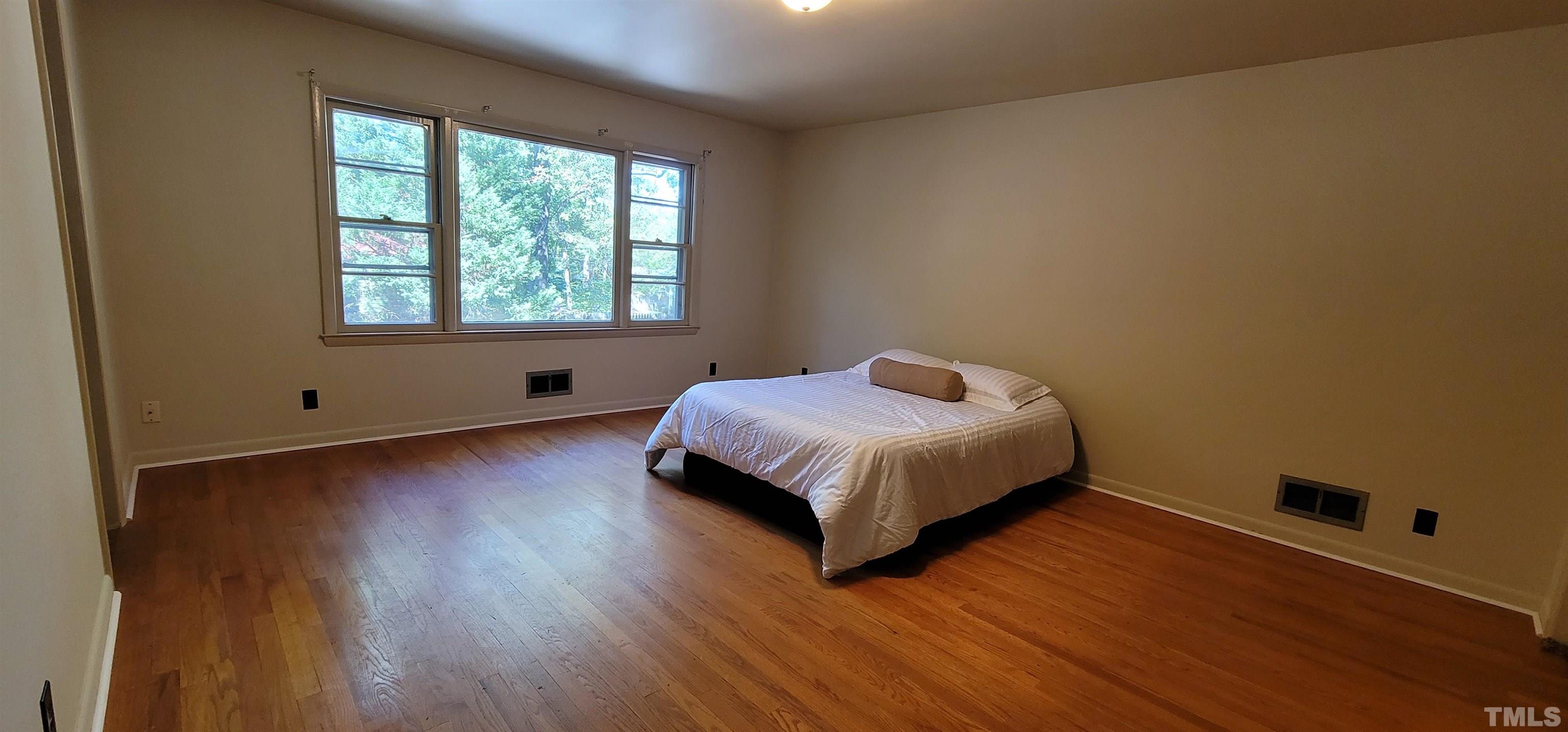 2245 Sheffield Road Raleigh, NC 27610 - Photo 5 of 8 a bed sitting in a bedroom next to a window