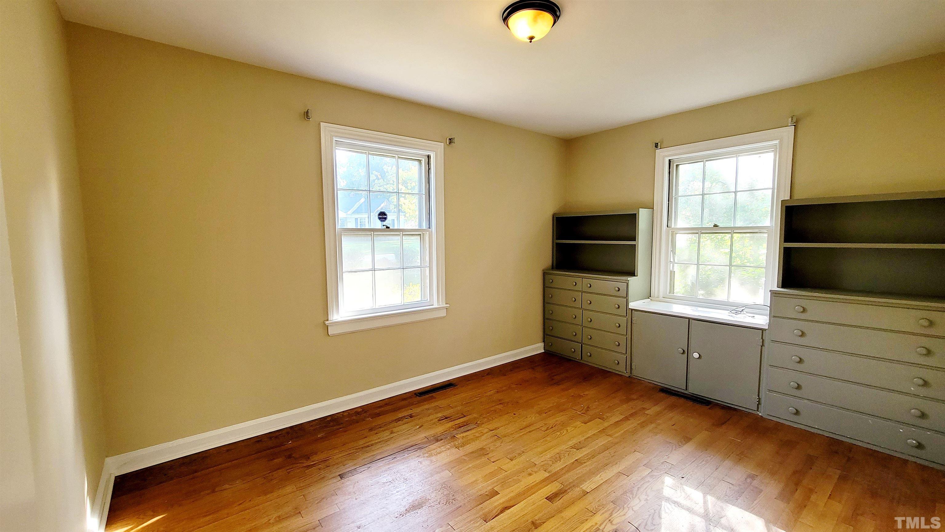 2245 Sheffield Road Raleigh, NC 27610 - Photo 6 of 8 a room with a dresser and a window