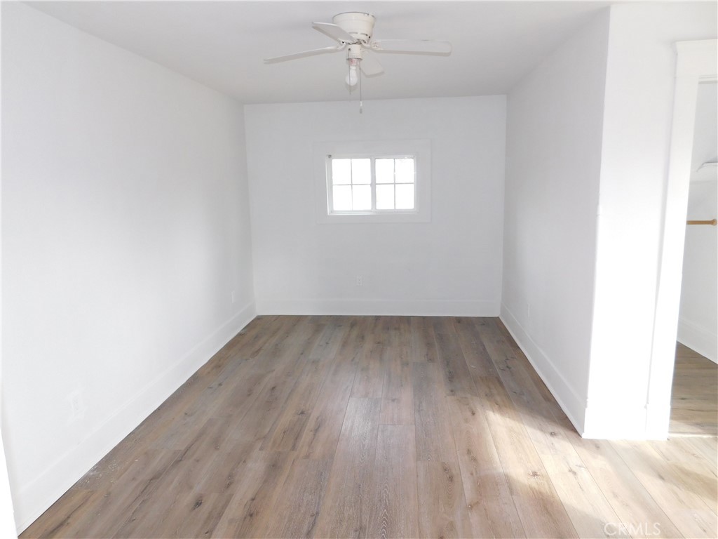 2626 5th Street Riverside, CA 92507 - Photo 17 of 31 an empty room with wooden floor and windows