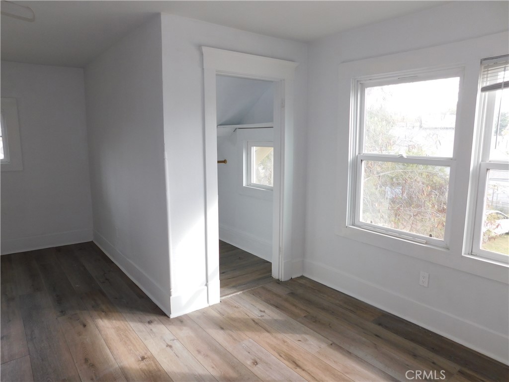 2626 5th Street Riverside, CA 92507 - Photo 18 of 31 an empty room with wooden floor and windows