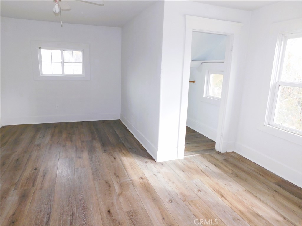 2626 5th Street Riverside, CA 92507 - Photo 19 of 31 an empty room with wooden floor and windows