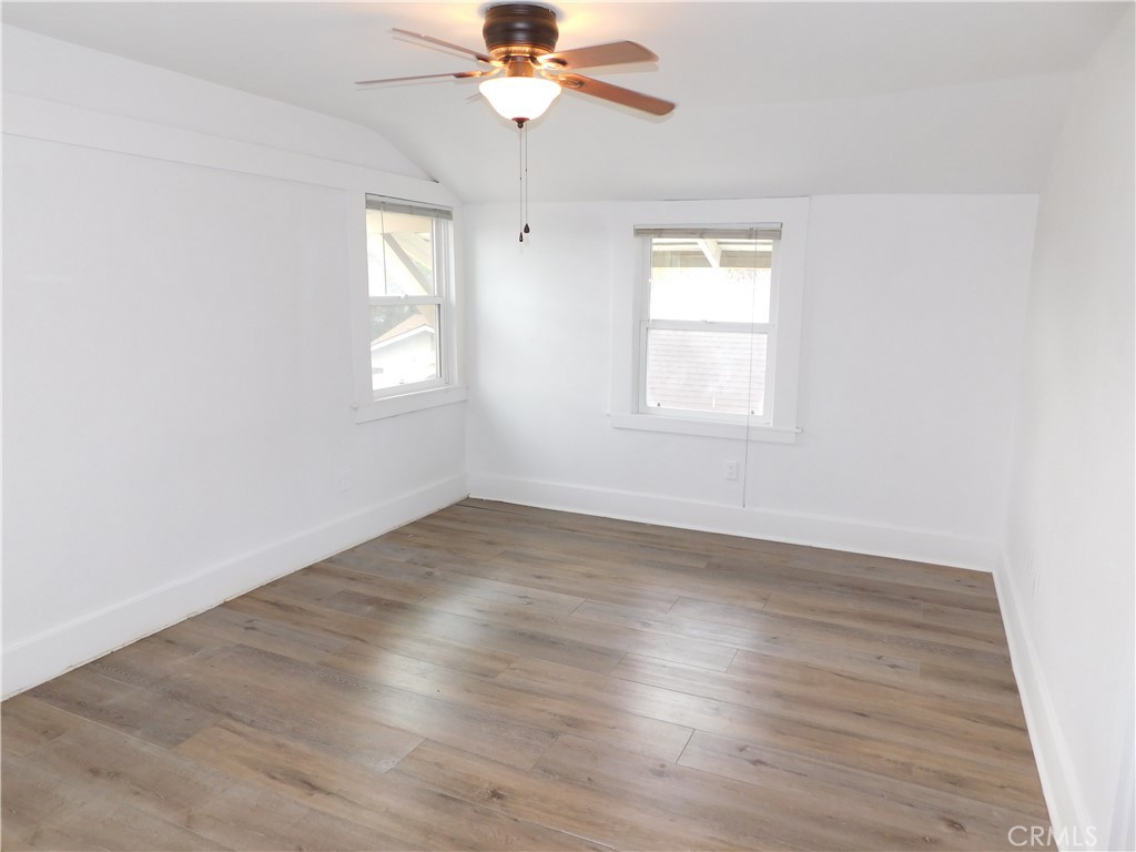 2626 5th Street Riverside, CA 92507 - Photo 25 of 31 an empty room with wooden floor fan and windows