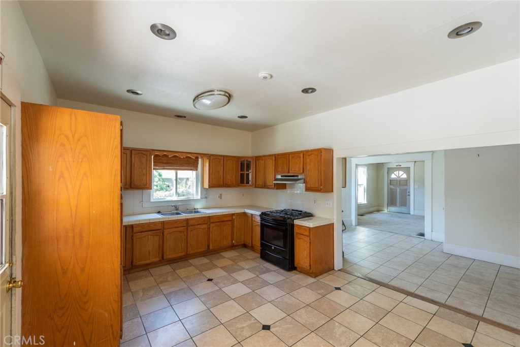 2626 5th Street Riverside, CA 92507 - Photo 8 of 31 a large kitchen with a sink and cabinets