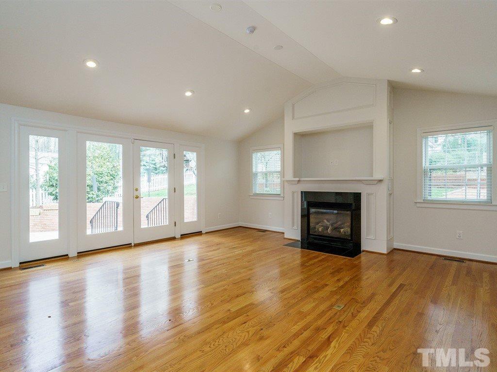 2456 Oxford Road Raleigh, NC 27608 - Photo 11 of 30 a view of an empty room with wooden floor and a window