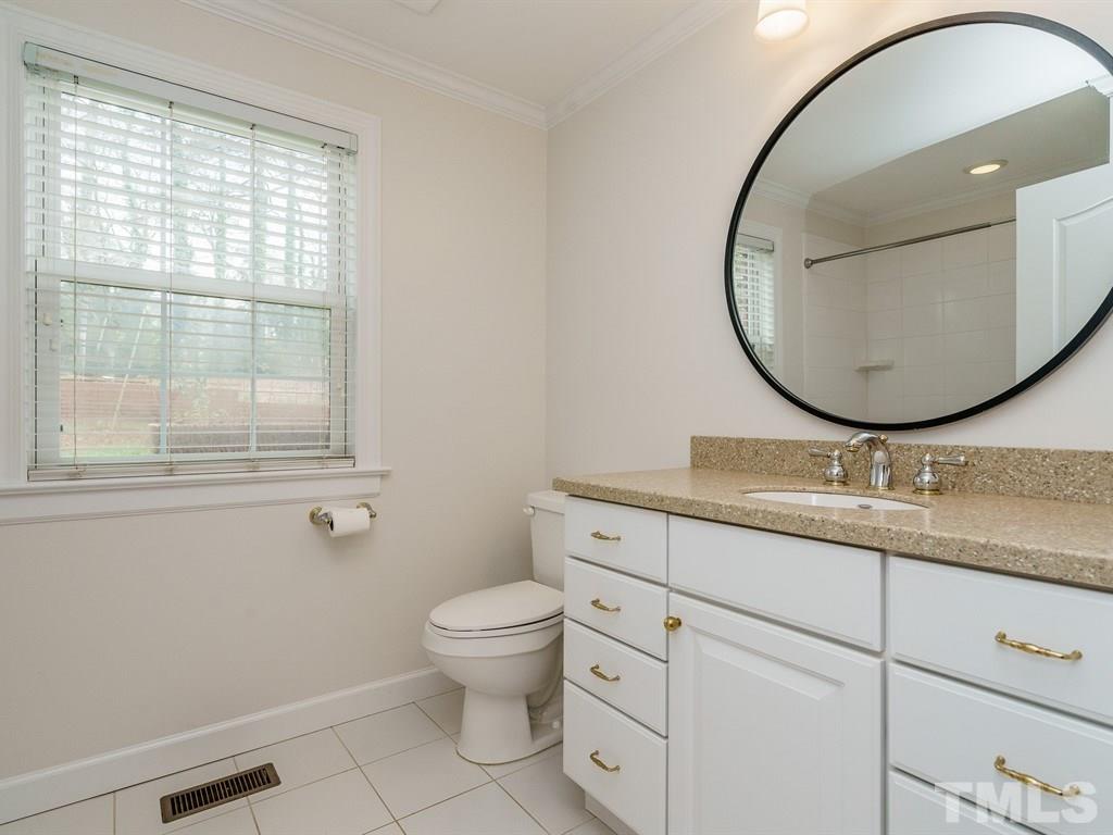 2456 Oxford Road Raleigh, NC 27608 - Photo 15 of 30 a bathroom with a granite countertop toilet a sink and mirror