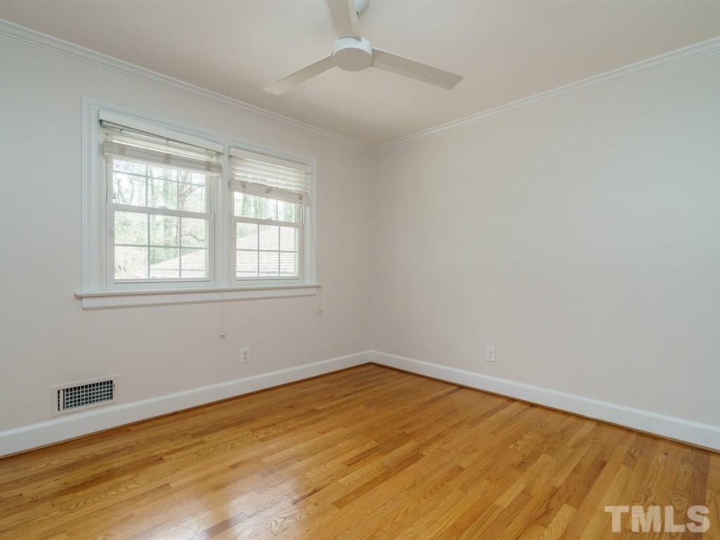 2456 Oxford Road Raleigh, NC 27608 - Photo 17 of 30 a view of empty room with wooden floor and fan