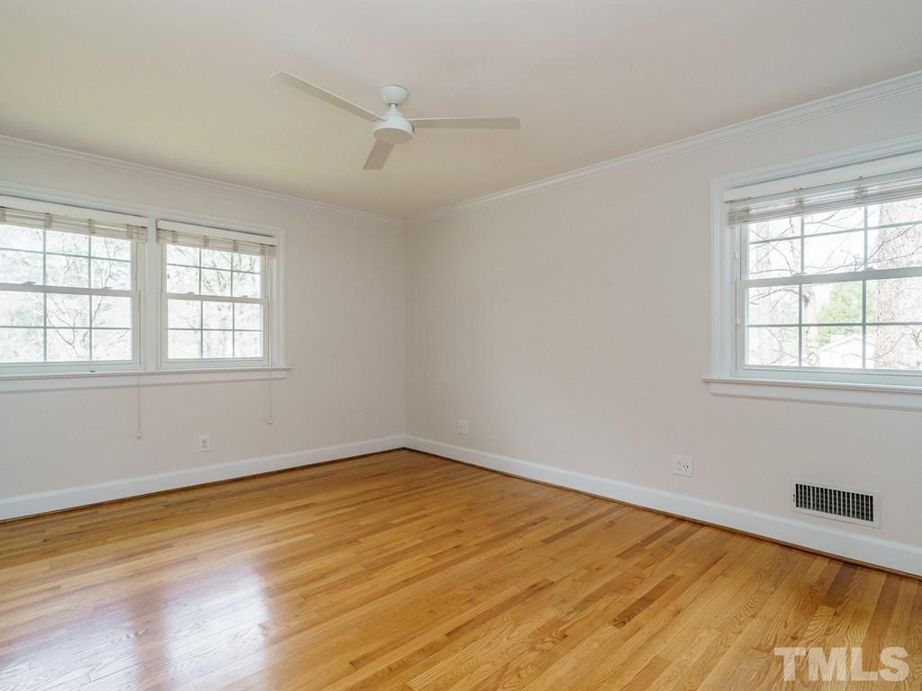 2456 Oxford Road Raleigh, NC 27608 - Photo 18 of 30 wooden floor in an empty room with a window