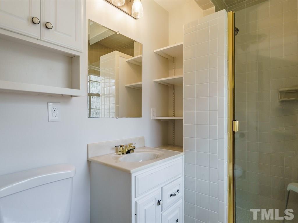 2456 Oxford Road Raleigh, NC 27608 - Photo 19 of 30 a bathroom with a sink and a mirror