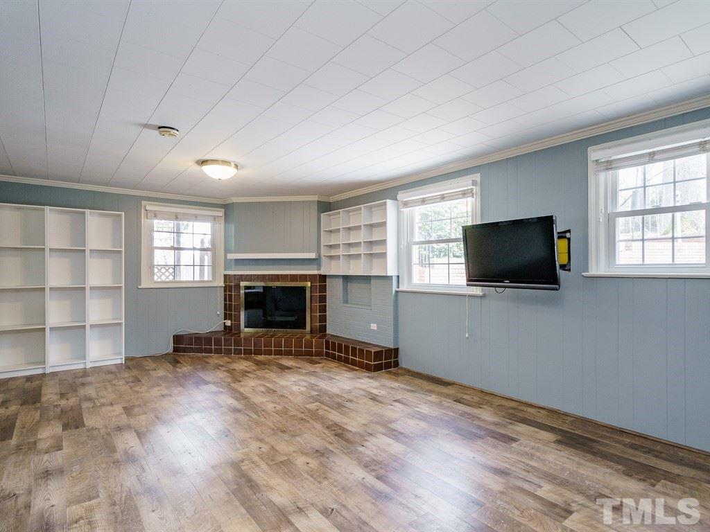 2456 Oxford Road Raleigh, NC 27608 - Photo 20 of 30 a view of an empty room with a fireplace and a window