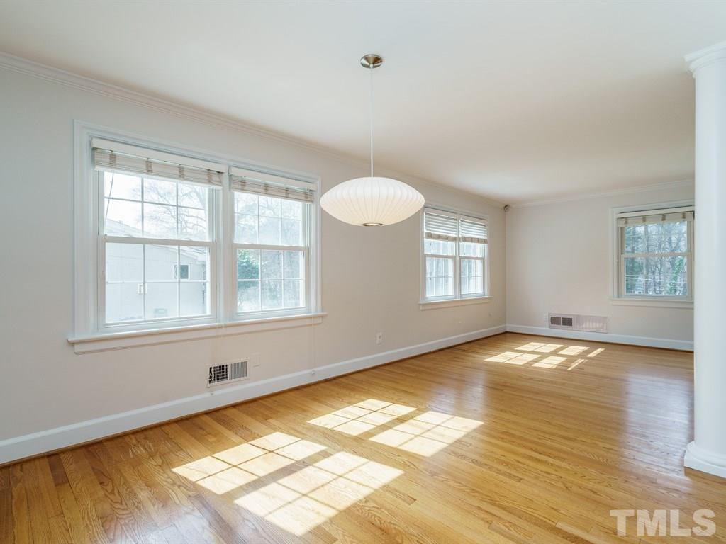 2456 Oxford Road Raleigh, NC 27608 - Photo 6 of 30 a view of an empty room with window and wooden floor