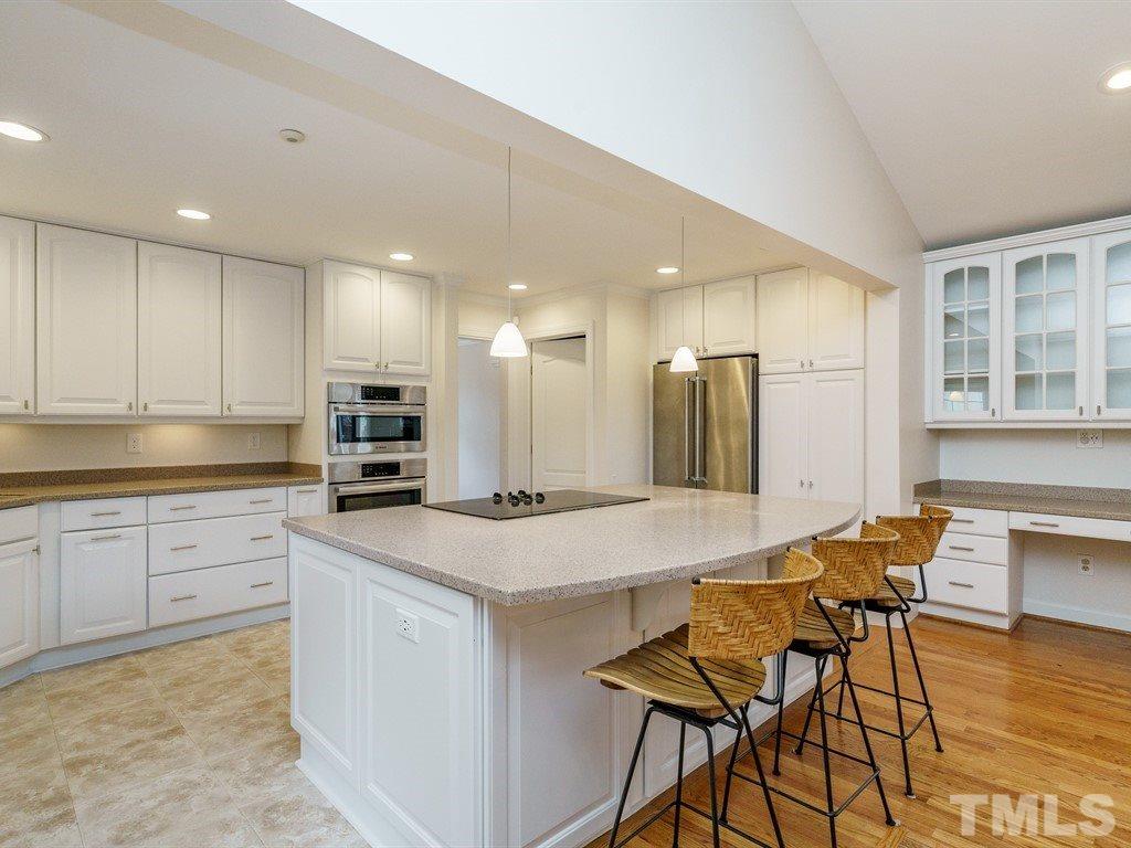2456 Oxford Road Raleigh, NC 27608 - Photo 7 of 30 a kitchen with stainless steel appliances granite countertop a table chairs sink and cabinets