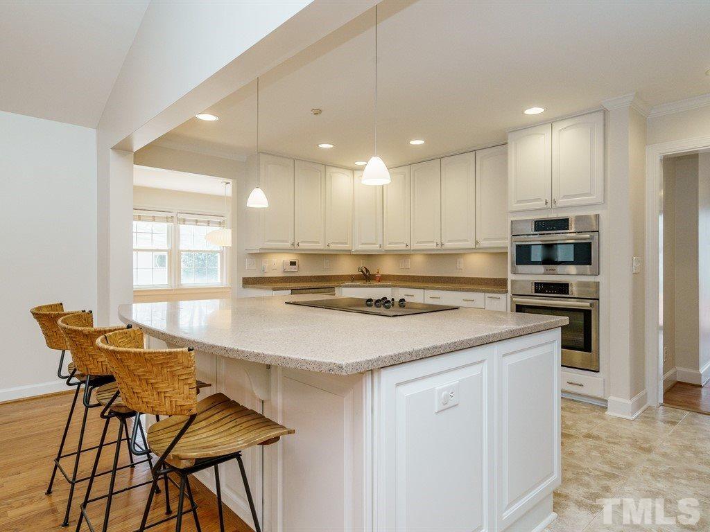 2456 Oxford Road Raleigh, NC 27608 - Photo 8 of 30 a kitchen with stainless steel appliances kitchen island granite countertop a stove and white cabinets