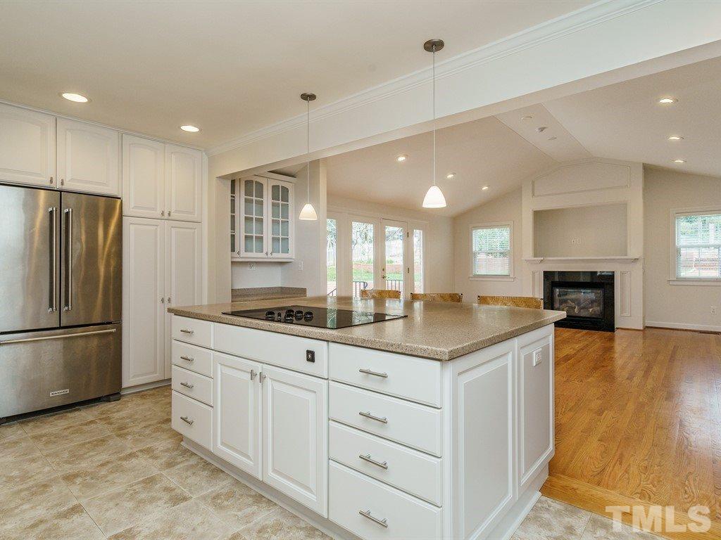 2456 Oxford Road Raleigh, NC 27608 - Photo 10 of 30 a kitchen with kitchen island a sink stainless steel appliances and counter space