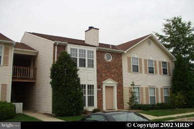 7820 Harrowgate Circle, Unit 105 Springfield, VA 22152 - Photo 1 of 11 a front view of a house with a yard and trees
