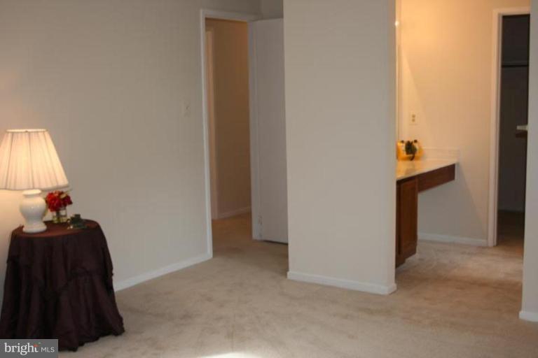 7820 Harrowgate Circle, Unit 105 Springfield, VA 22152 - Photo 2 of 11 a view of hallway with livingroom