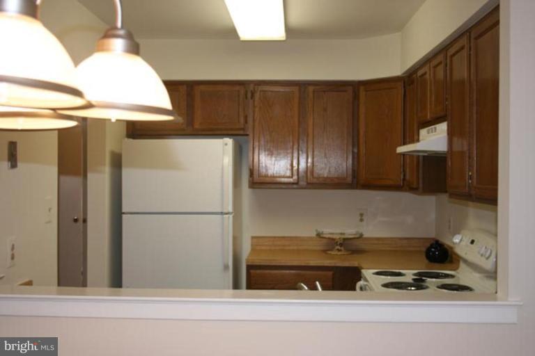 7820 Harrowgate Circle, Unit 105 Springfield, VA 22152 - Photo 4 of 11 a bathroom with a refrigerator and a sink