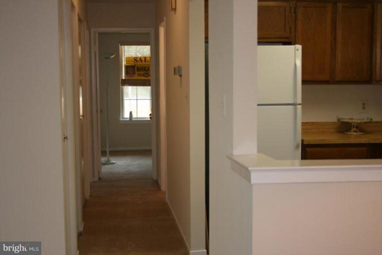 7820 Harrowgate Circle, Unit 105 Springfield, VA 22152 - Photo 7 of 11 a view of a kitchen from the hallway