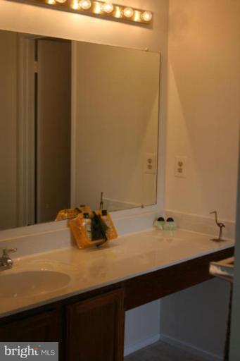 7820 Harrowgate Circle, Unit 105 Springfield, VA 22152 - Photo 8 of 11 a bathroom with a sink and a mirror