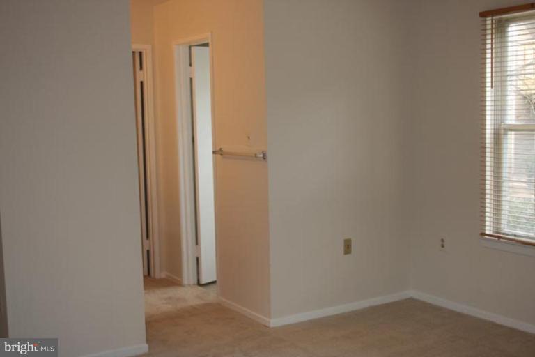 7820 Harrowgate Circle, Unit 105 Springfield, VA 22152 - Photo 9 of 11 a view of hallway with windows