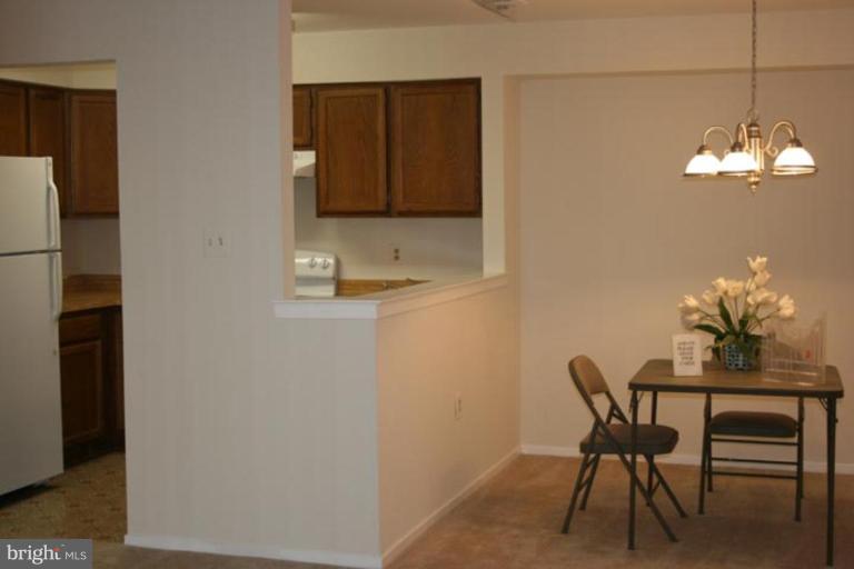 7820 Harrowgate Circle, Unit 105 Springfield, VA 22152 - Photo 10 of 11 a dining room with furniture and window