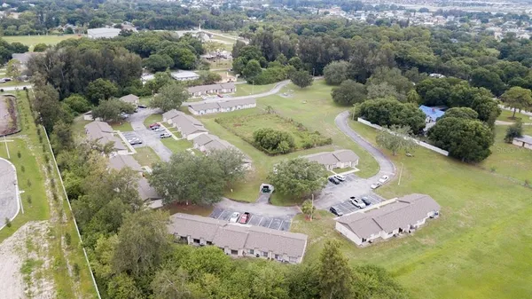 an aerial view of residential house with outdoor space and swimming pool