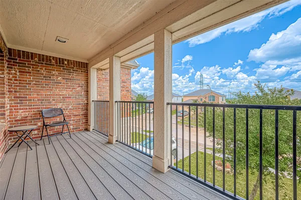 a view of a balcony with wooden floor