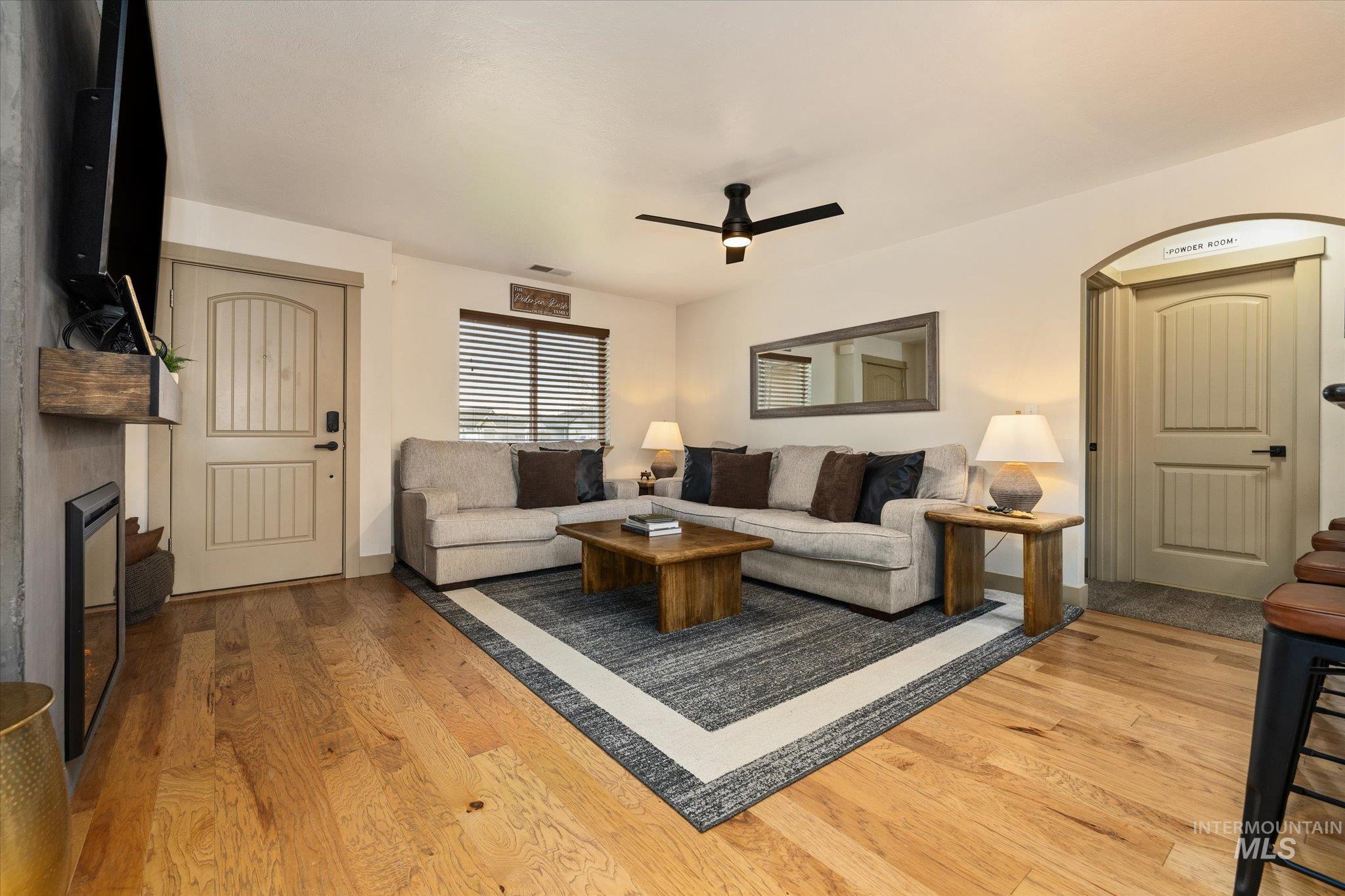 1065 West 11th Street Weiser, ID 83672 - Photo 12 of 48 Living room featuring light wood-style floors, a ceiling fan, and a fireplace