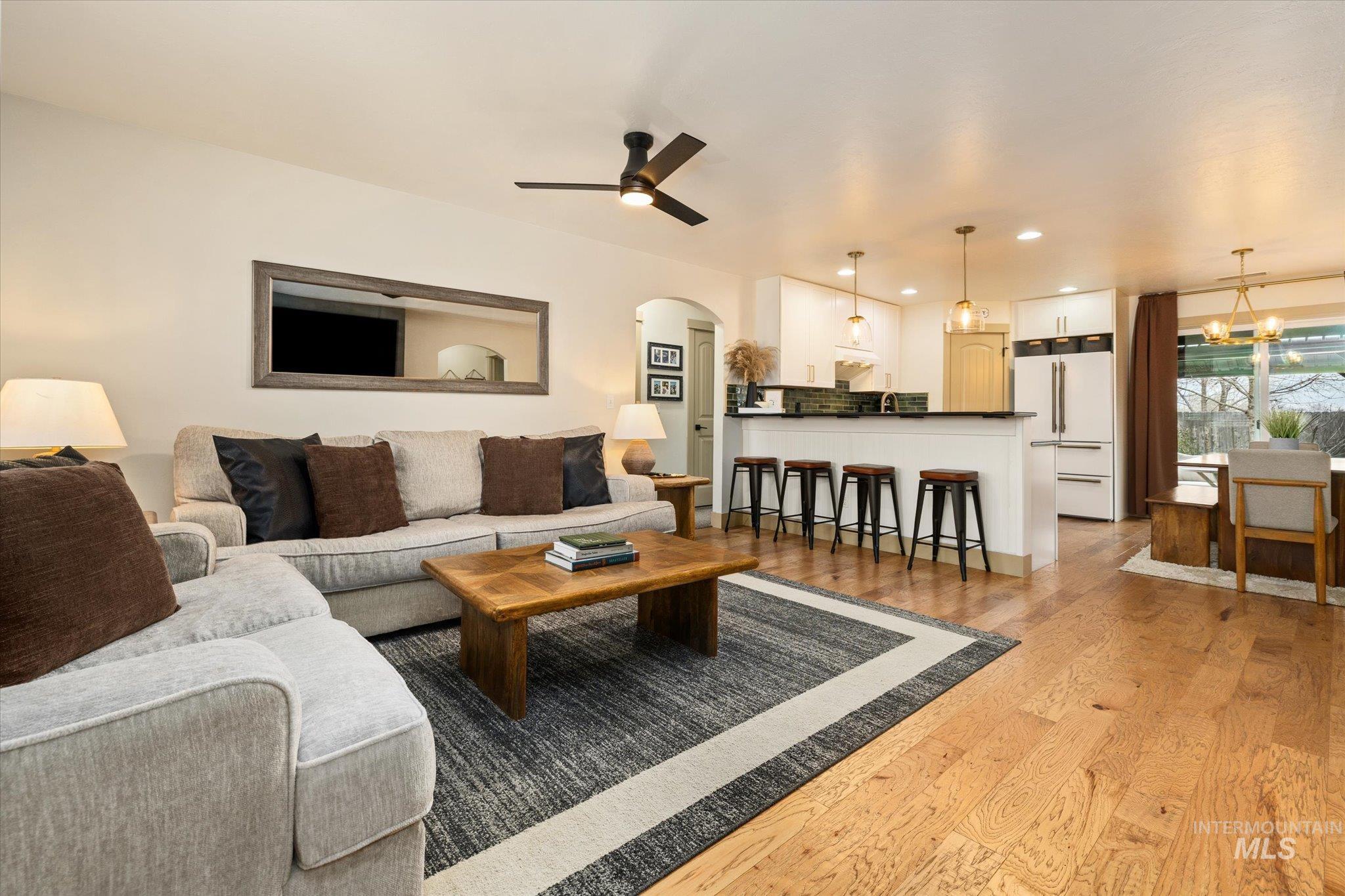 1065 West 11th Street Weiser, ID 83672 - Photo 13 of 48 Living area with arched walkways, light wood finished floors, ceiling fan, and recessed lighting