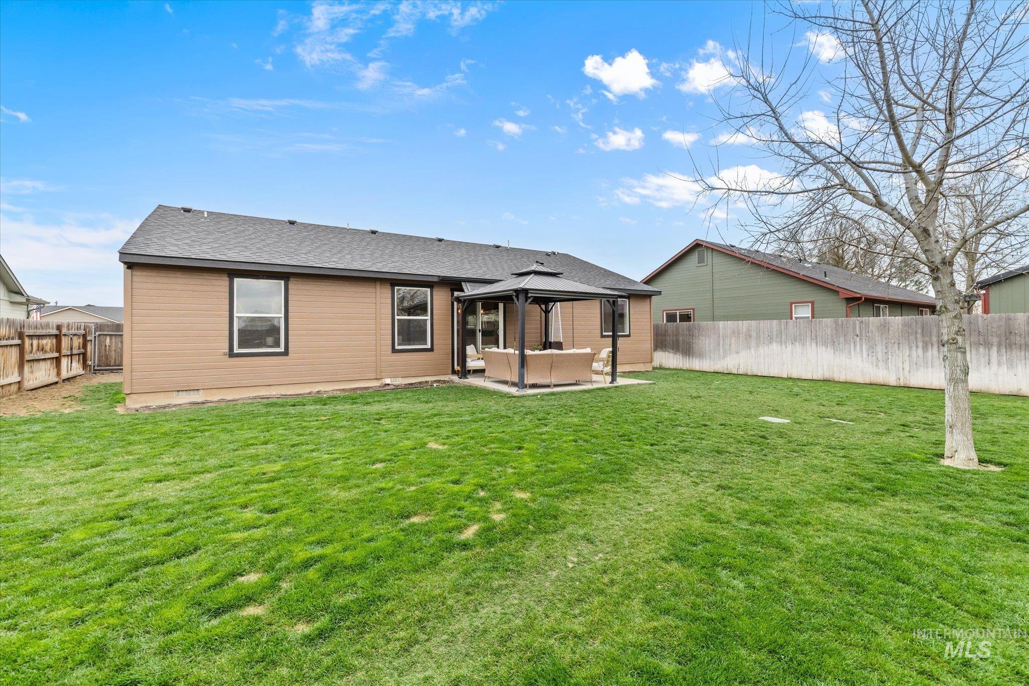 1065 West 11th Street Weiser, ID 83672 - Photo 41 of 48 Rear view of property with a patio area, a gazebo, roof with shingles, a fenced backyard, and outdoor furniture