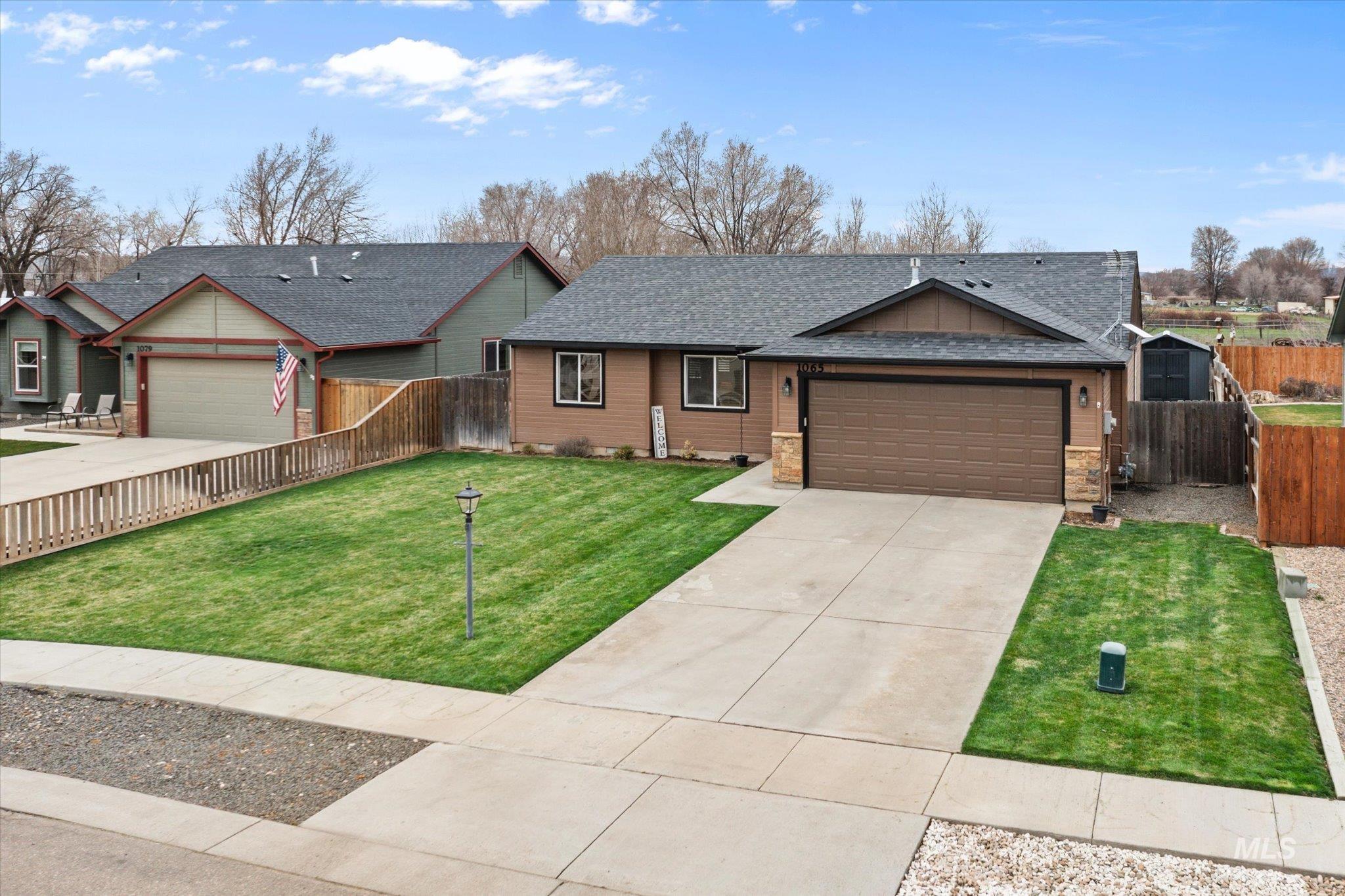 1065 West 11th Street Weiser, ID 83672 - Photo 47 of 48 Ranch-style house featuring an attached garage, driveway, and roof with shingles