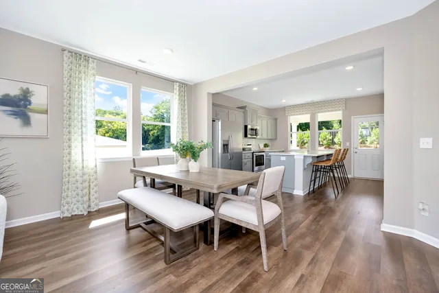 a view of a dining room with furniture and wooden floor