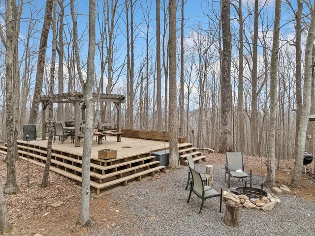 a view of a chairs and tables in the back yard of the house