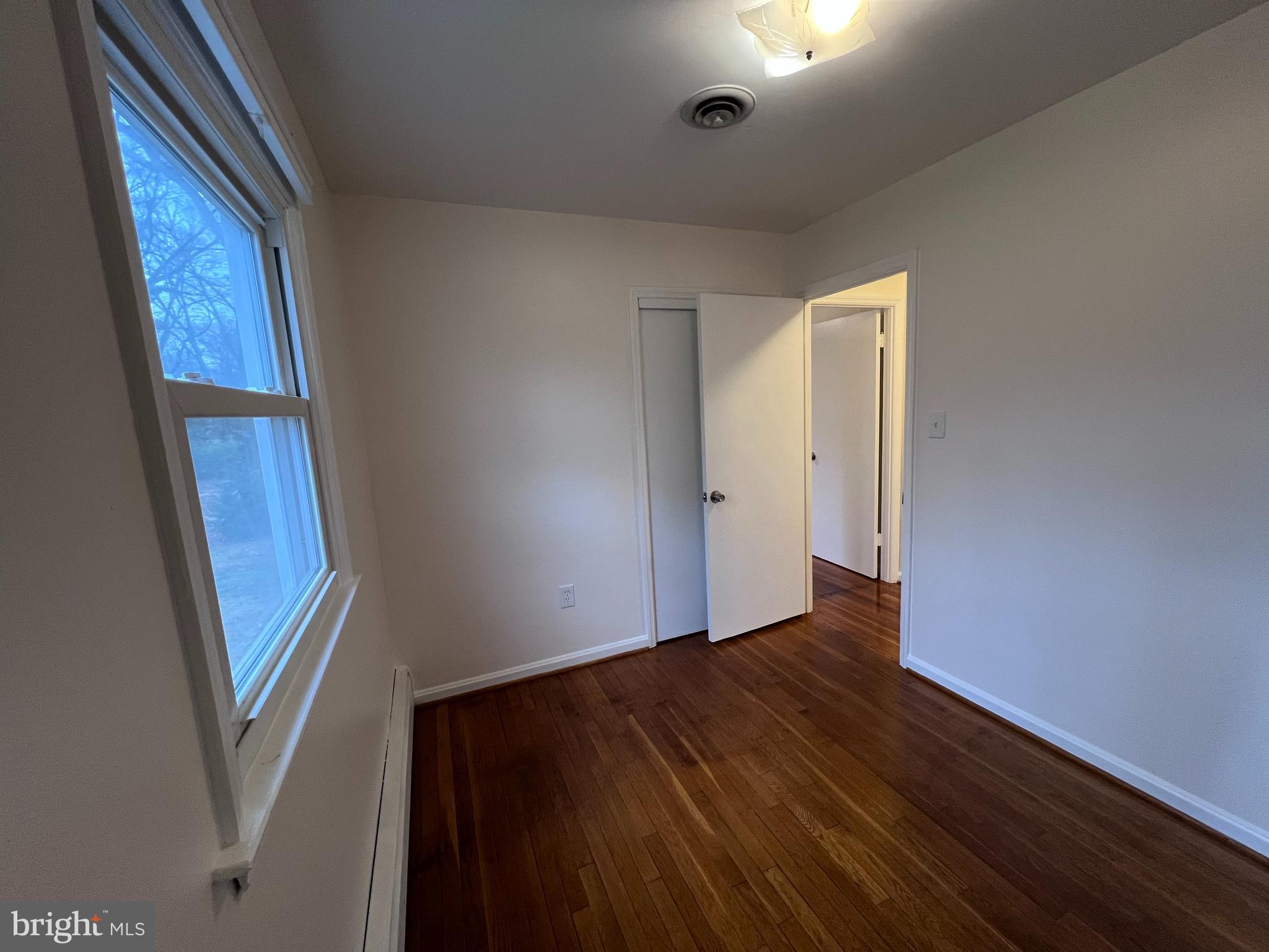 155 Sillery Bay Road Pasadena, MD 21122 - Photo 17 of 34 an empty room with wooden floor and windows
