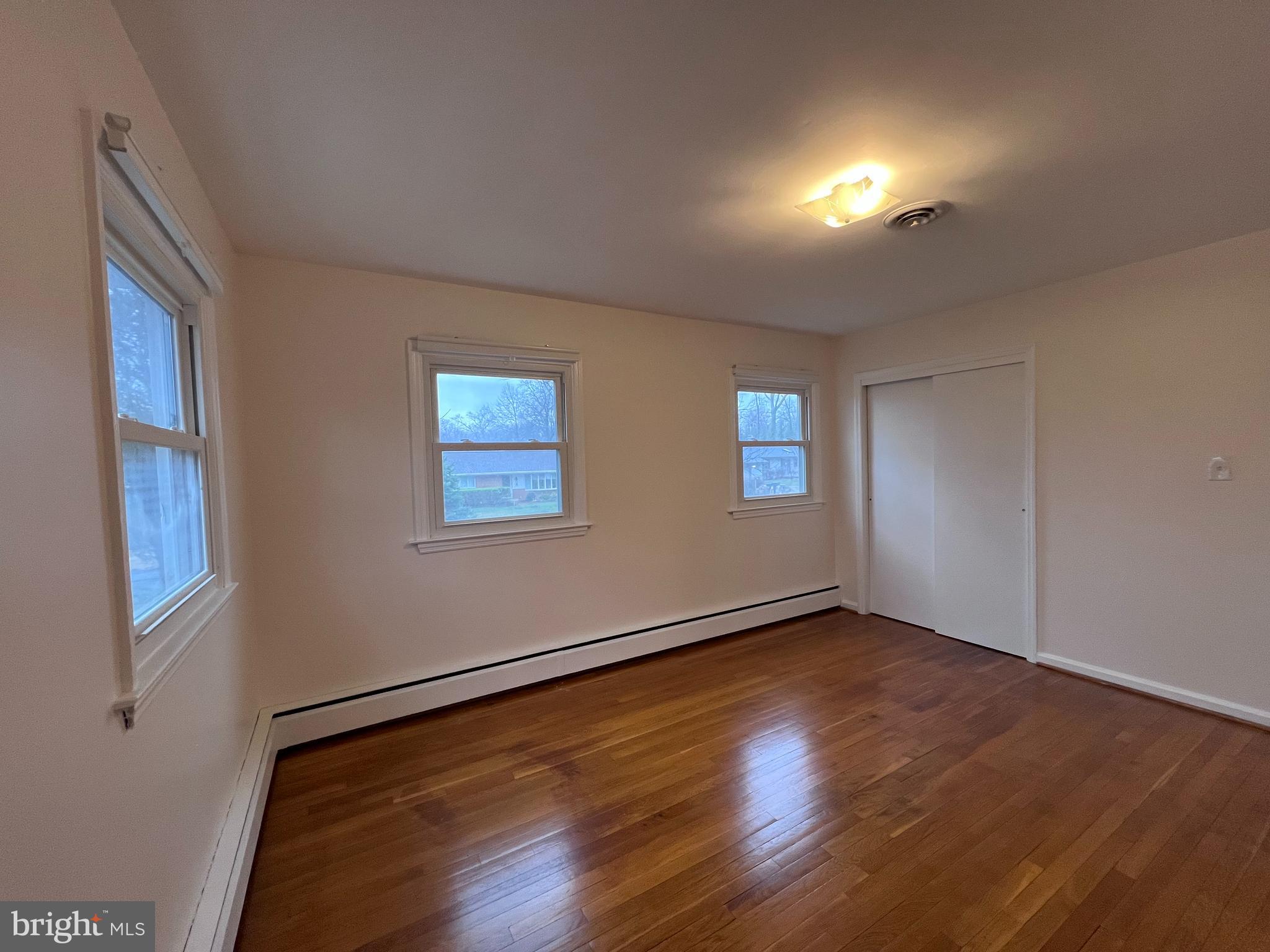 155 Sillery Bay Road Pasadena, MD 21122 - Photo 20 of 34 a view of an empty room with wooden floor and a window
