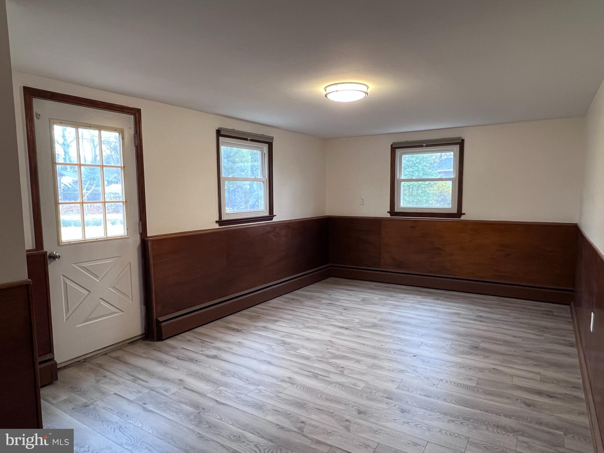 155 Sillery Bay Road Pasadena, MD 21122 - Photo 21 of 34 an empty room with wooden floor and windows