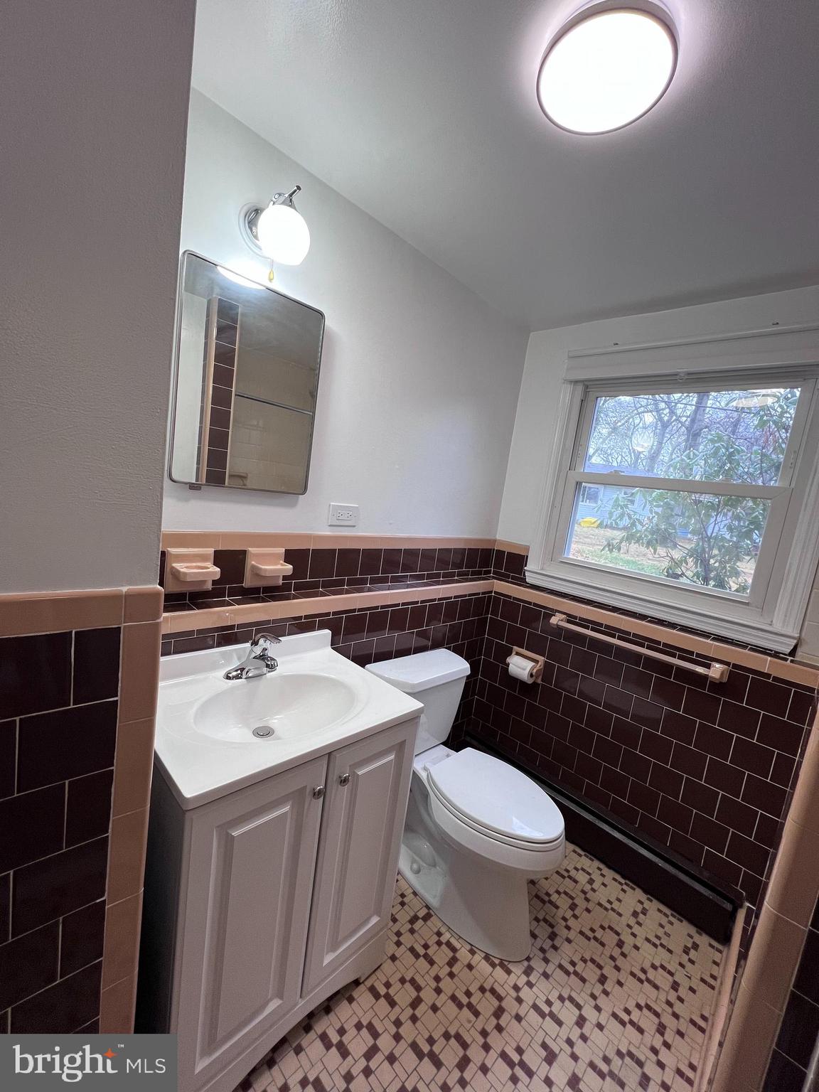 155 Sillery Bay Road Pasadena, MD 21122 - Photo 22 of 34 a bathroom with a sink a toilet a mirror and window