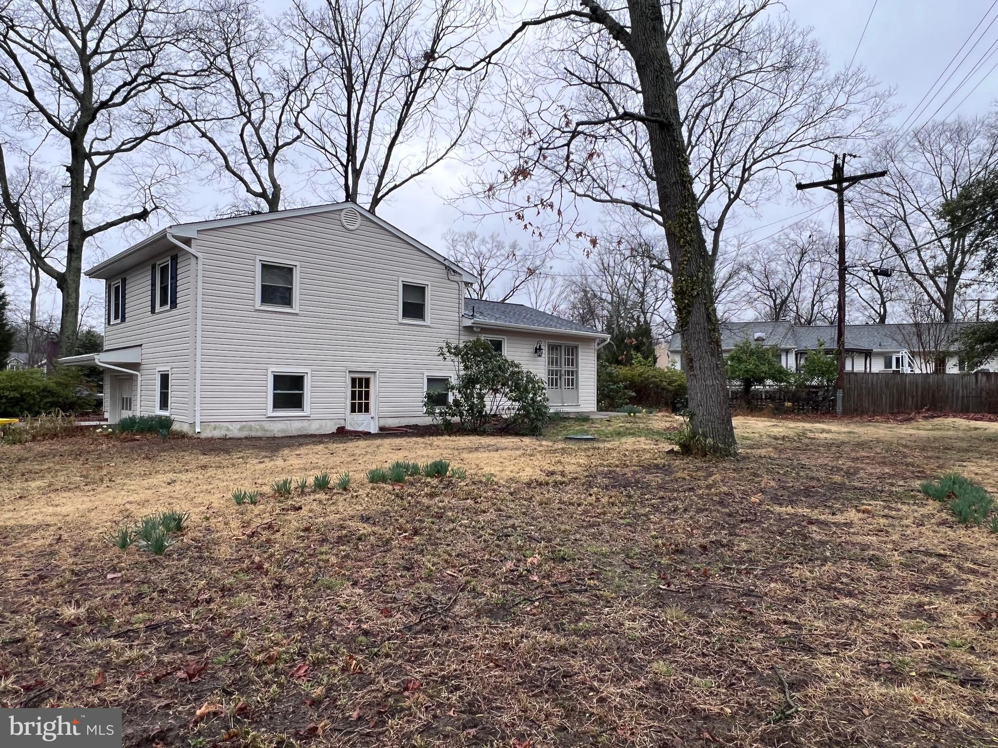 155 Sillery Bay Road Pasadena, MD 21122 - Photo 26 of 34 a view of a white house with a yard covered in snow